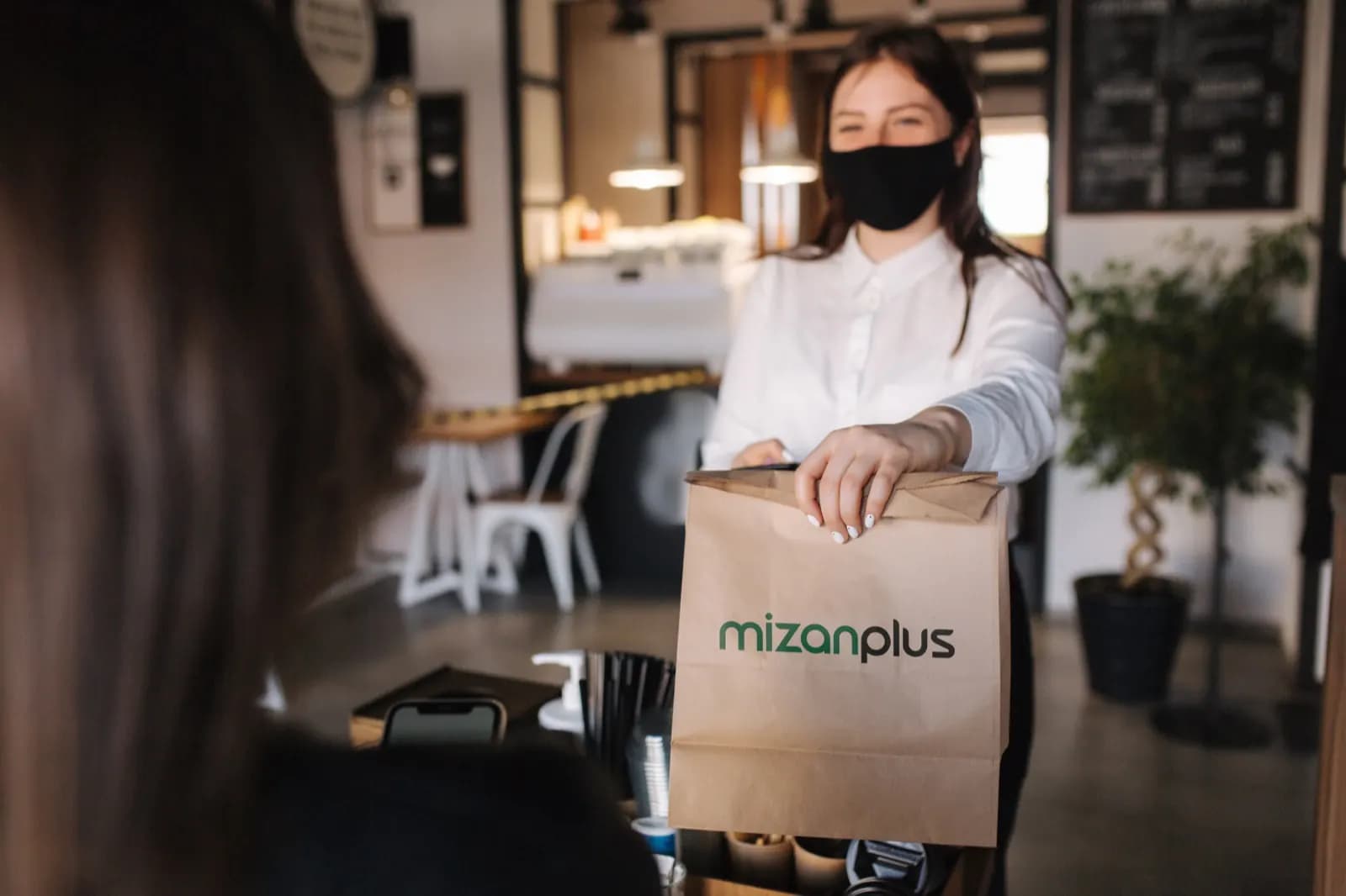 A Mizanplus delivery order being handed over
